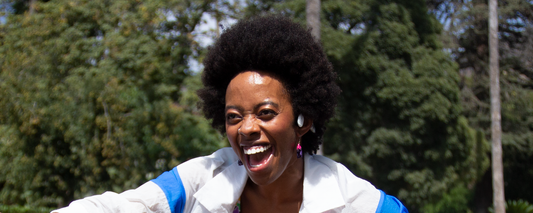 Woman wearing Shokz OpenMove wireless headphones and listening to music